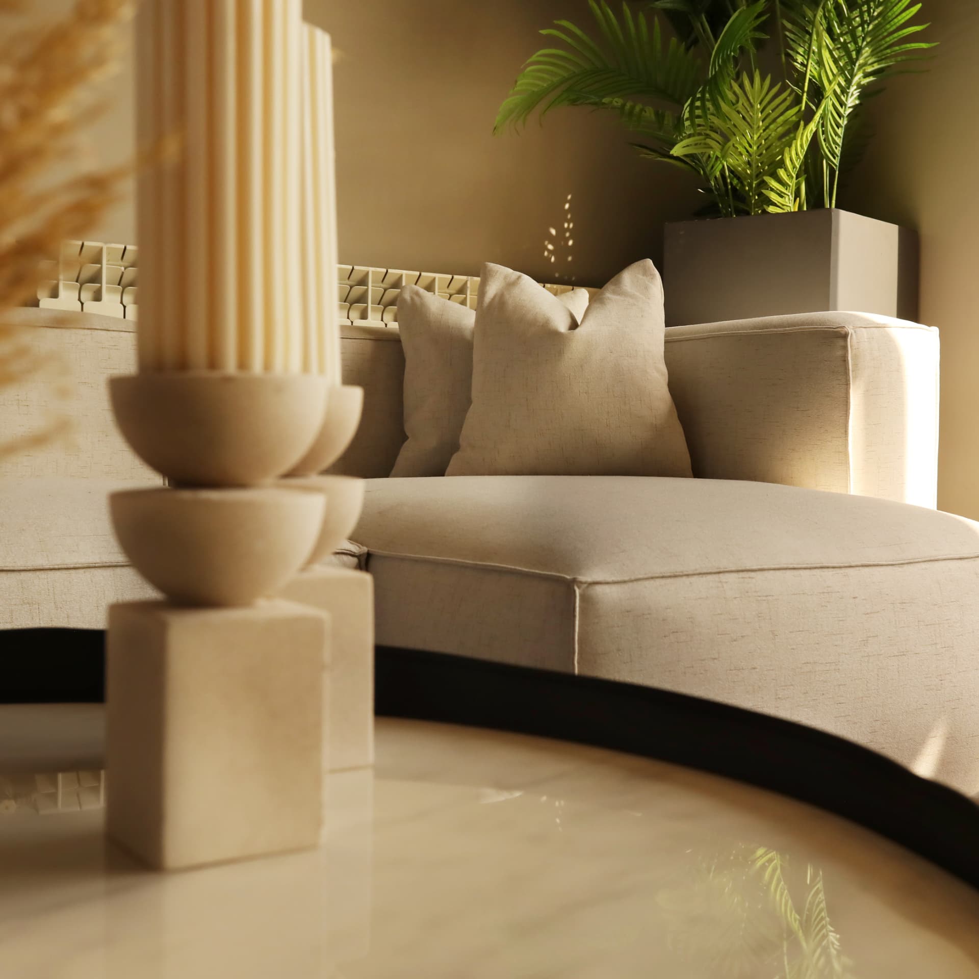 Detail of a linen sofa, fluted stone lamp and marble table in the New Martakla Apartment