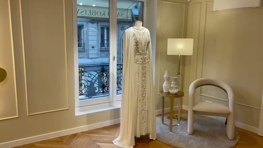 High fashion Parisian showroom interior with panelled walls and warm display lighting